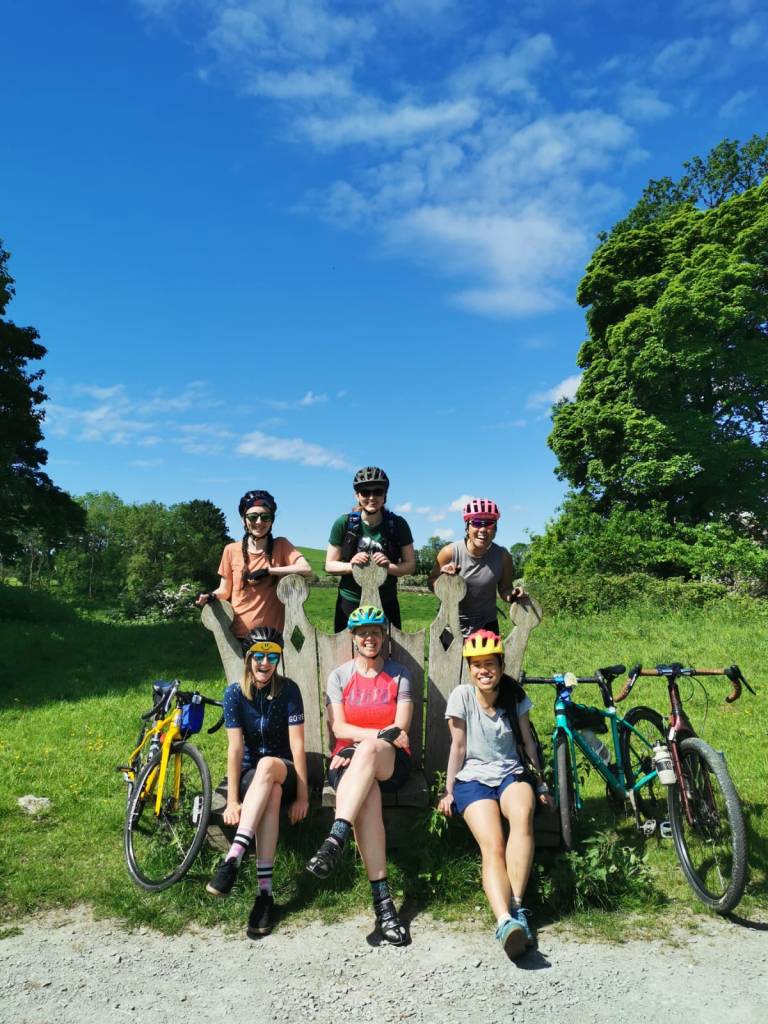 group of women sat on a crown shaped bench