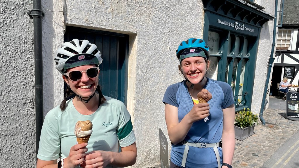 two women with big smiles eating icecream