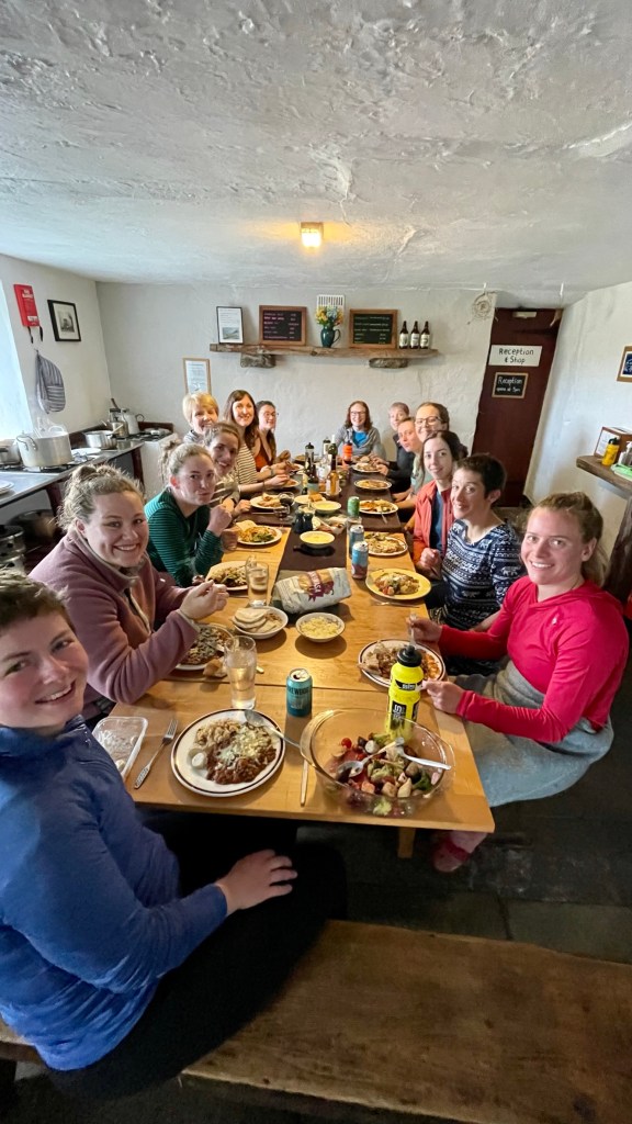 A group of women sitting around a big table eating dinner