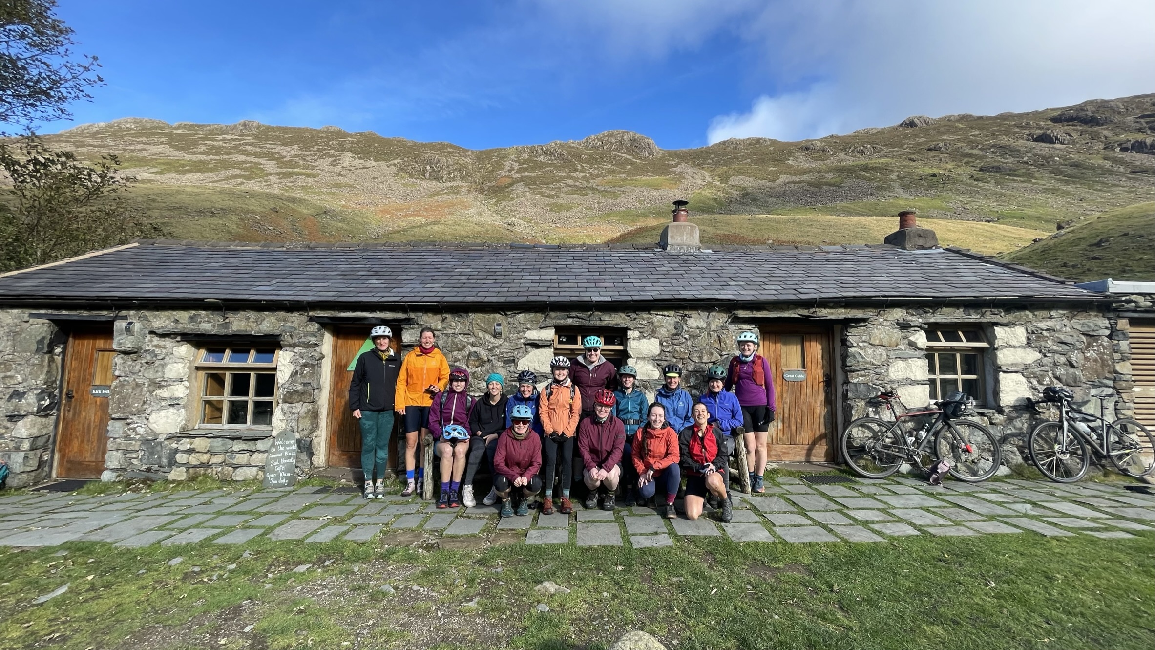 group of women in colourful jackets posing for a group photo