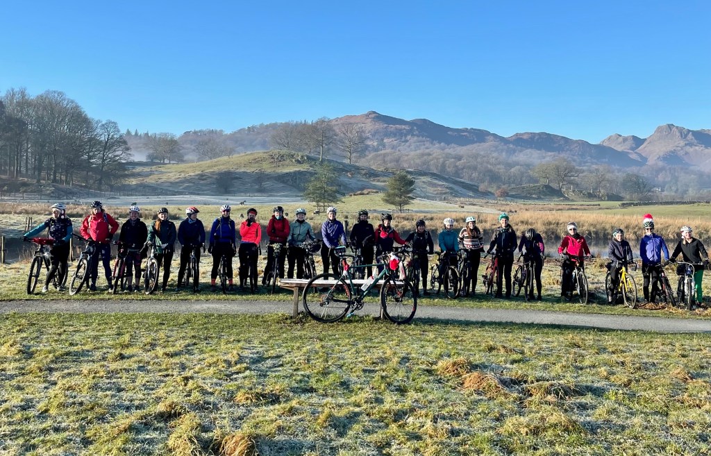 large group of women on bikes posing for a group photo